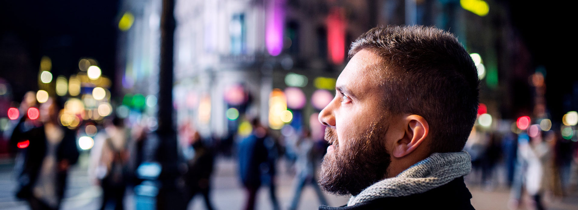 Un homme en pleine rue dans une ville active, le regard lointain - global secure