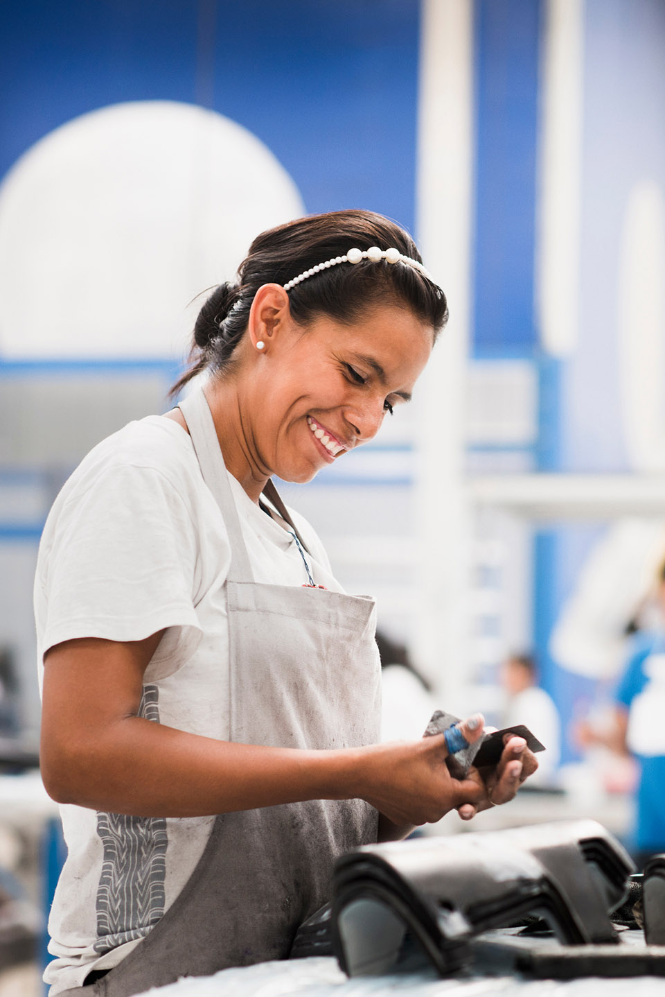 Worker smiling in manufacturing plant