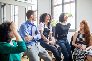 Un groupe de collègues discutant joyeusement ensemble - baromètre AXA